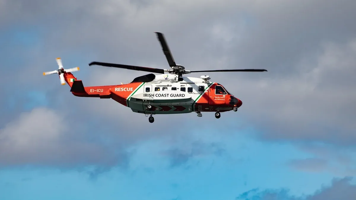 A helicopter flying in the sky, with the words "IRISH COAST GUARD" and "RESCUE" visible on its side.